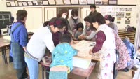 子どもと留学生が餅つき